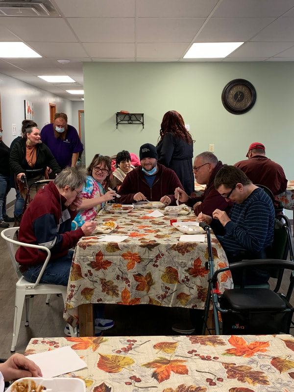 Photo of Champaign County Board of DD SSA eating a Thanksgiving meal with PCS clients