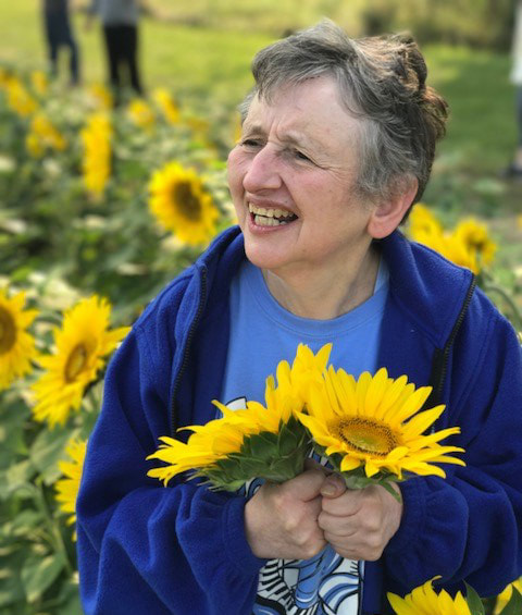photo of woman in sunflower field